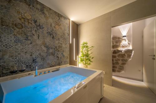 a large tub in a bathroom with a shower at Kaldanac Residence in Rab