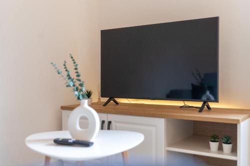 a flat screen tv sitting on top of a table at Kaldanac Residence in Rab