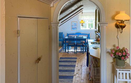 a kitchen and dining room with an archway in a house at 1 Bedroom Nice Apartment In Sjötorp in Sjötorp