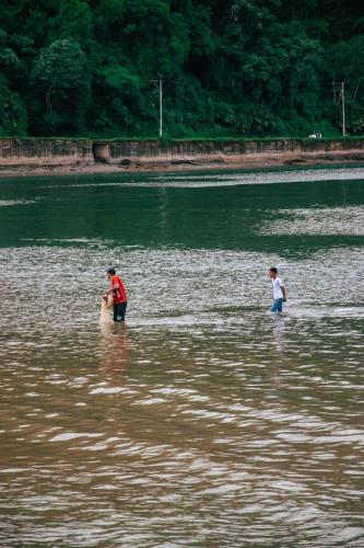 two people are standing in a body of water at The Humpback Turtle in El Valle
