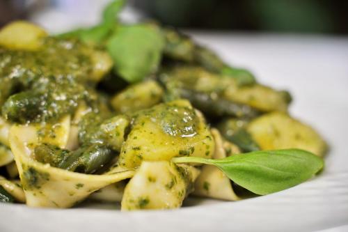 a plate of food with broccoli and green sauce at Antica Locanda Luigina in Mattarana