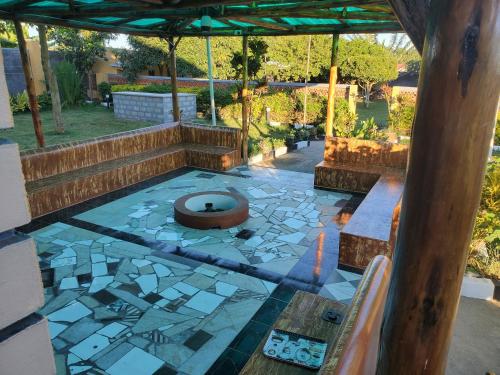 an outdoor patio with a toilet in the middle at Alice Gardens and Campsite in Entebbe