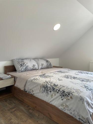 a bed with two pillows on it in a bedroom at Apartmani Vrla NEW in Vladičin Han