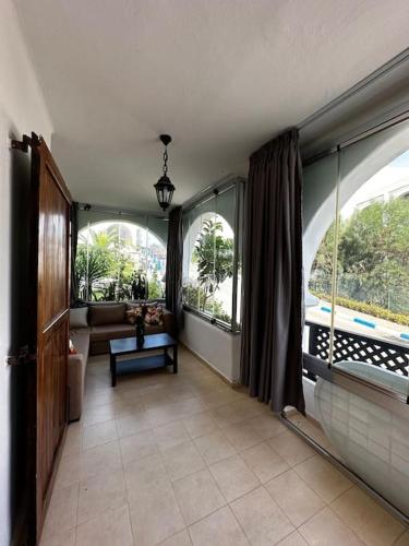 a living room with large windows and a couch at Appartement bella vista in Cabo Negro