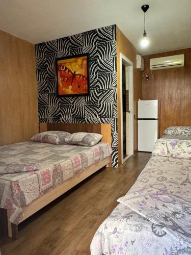 a room with two beds and a painting on the wall at apartamienty "Pozitiv" in Karolino-Buhaz