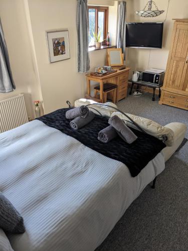 a bedroom with a large bed with towels on it at South Barn in Stanningfield