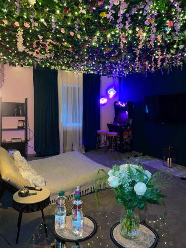 a room with a bed with flowers and lights at Suite mit Whirlpool, Sauna, Pole Dance und mehr in Essen