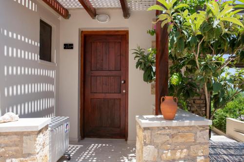 an entrance to a house with a wooden door at Stefanos Village Hotel in Plakias