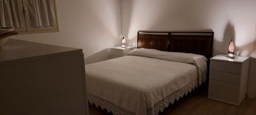 a bedroom with a bed and two night stands at Casa Giulia in Castelbuono