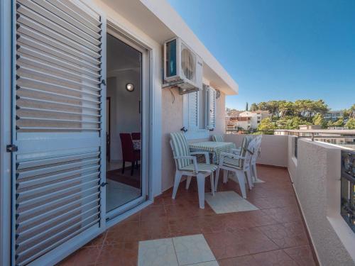 a balcony with a table and chairs on a balcony at Apartments Marina in Sveti Stefan