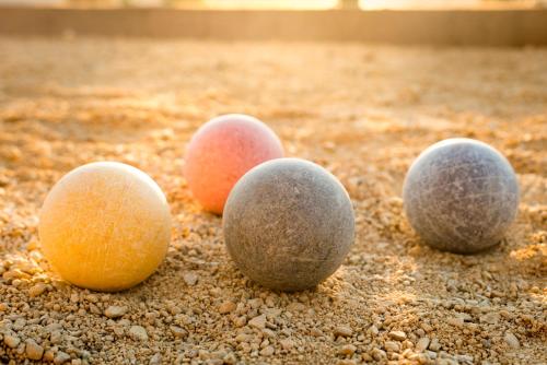 four different colored balls sitting on the ground at Allegretto Vineyard Resort Paso Robles in Paso Robles