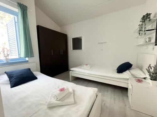 a bedroom with two beds and a window at SeaFun Apartment Gajac in Gajac