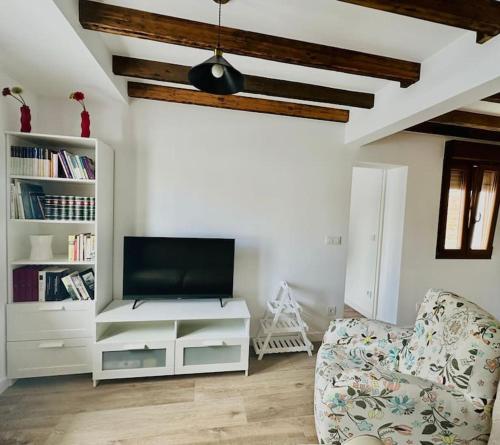 a living room with a tv and a couch at Apto-1 Pedreña Golf y Surf in Pedreña