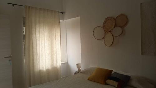 a bedroom with a bed and a window at Kepos room in Tortolì