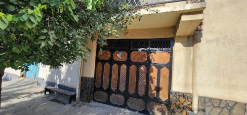a iron gate on the side of a building at Sim-Sim Hostel in Panjakent