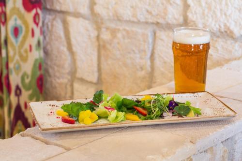 a plate of food and a glass of beer at Allegretto Vineyard Resort Paso Robles in Paso Robles