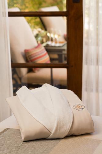 a white towel sitting on top of a bed at Allegretto Vineyard Resort Paso Robles in Paso Robles