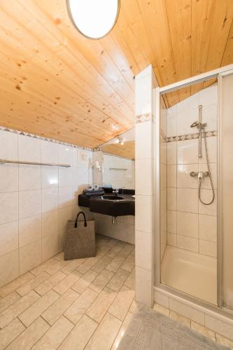a bathroom with a shower and a sink at Feriengut Hasenau in Saalbach-Hinterglemm