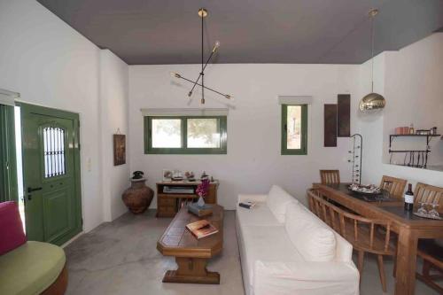 a living room with a white couch and a table at Korasida View Apartment in Akhladherí