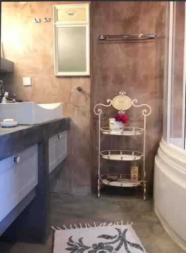 a bathroom with a sink and a toilet and a sink at Korasida View Apartment in Akhladherí