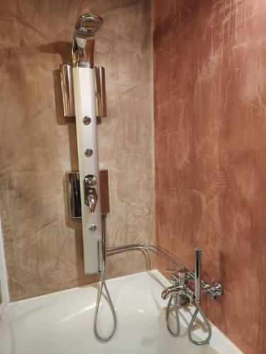 a bathroom with a sink with a light on the wall at Korasida View Apartment in Akhladherí