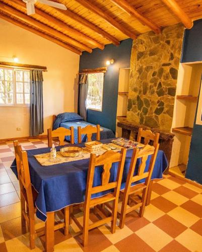 a dining room with a table and chairs at cabañas Villa de las rosas in Villa de Las Rosas