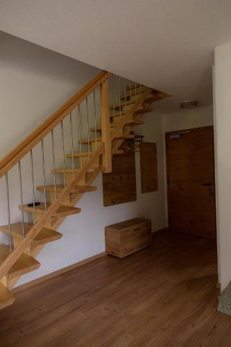 a staircase in a room with a wooden floor at Ferienwohnung am Bauernhof, Korbingerhof in Rinn