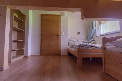 a bedroom with a bunk bed and a door at Ferienwohnung am Bauernhof, Korbingerhof in Rinn