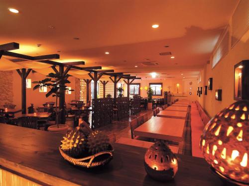 a restaurant with wooden tables and chairs and tables at Community & Spa Naha Central Hotel in Naha