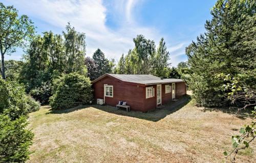 a small house in the middle of a yard at Nice Home In Græsted With Kitchen in Græsted