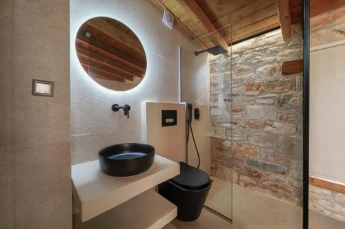 a bathroom with a sink and a mirror at Brothers Studios & Suites in Skala Potamias