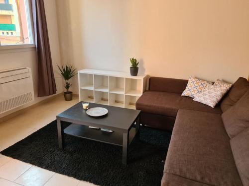 a living room with a couch and a coffee table at Propriano logement climatisé terrasse proche port in Propriano