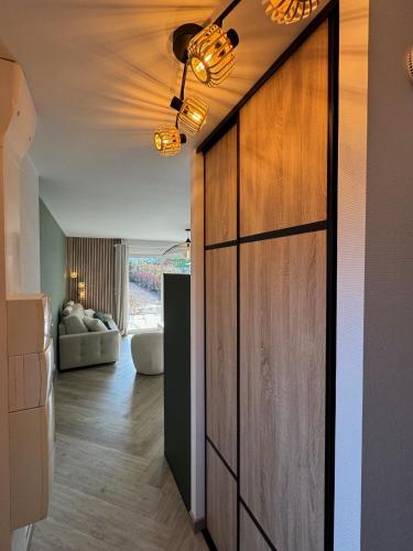 une chambre avec une grande porte en bois et un salon dans l'établissement Appartement terrasse et jardin, à Saint-Julien-les-Villas