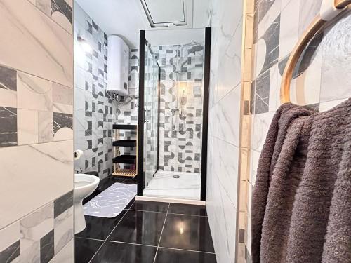 a bathroom with a shower and a toilet at Apartment Žega in Kaštela