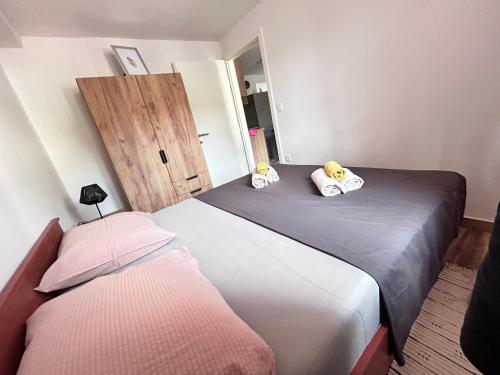 a bedroom with two beds and a door at Apartment Žega in Kaštela