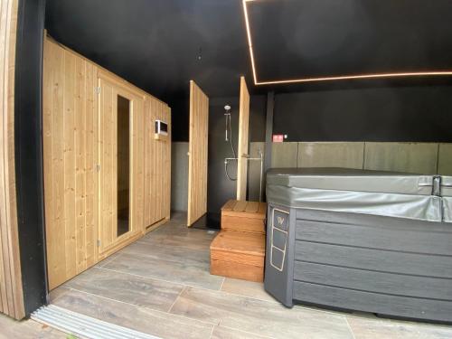 a bathroom with a tub and a shower in it at Gîte de la Tour in Hotton