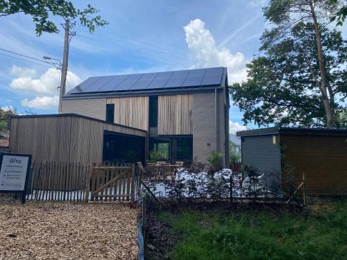 a house with solar panels on the side of it at Gîte de la Tour in Hotton