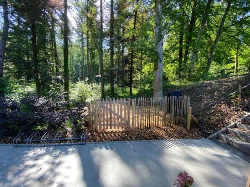 a wooden fence in the middle of a forest at Gîte de la Tour in Hotton