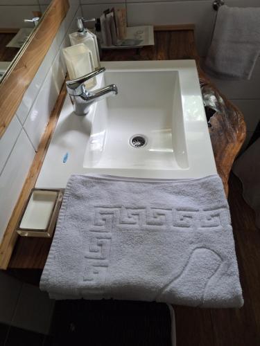 a bathroom sink with a towel on a counter at ATRIUM Holiday home in Bihać