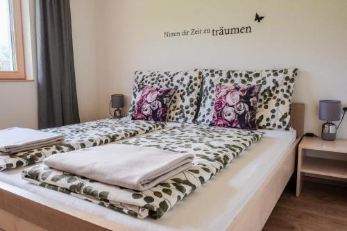 a bed with pillows on it in a room at 751Pelzrain in Bezau