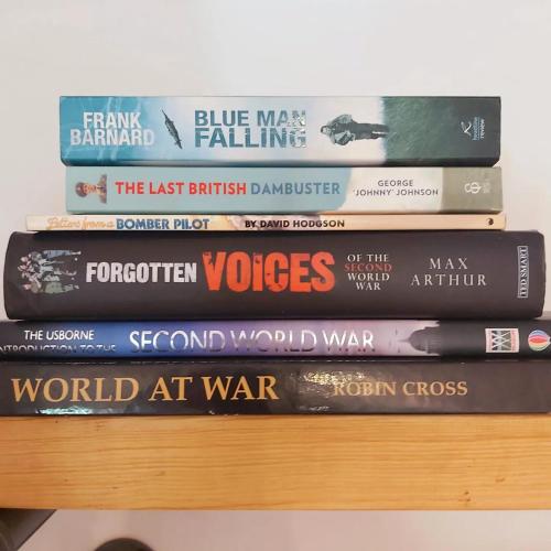 a stack of books sitting on top of a shelf at The Ram at Tivetshall in Tivetshall Saint Margaret