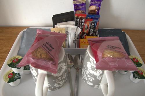 a tray with two spoons and two bags of food at The Ram at Tivetshall in Tivetshall Saint Margaret