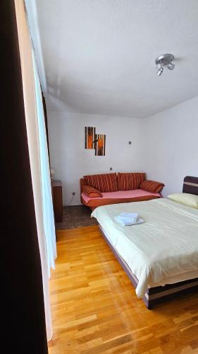 a room with two beds and a couch in it at M&M Bazen resort Goražde in Goražde