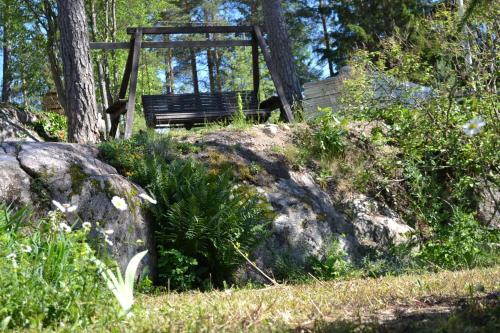 a park bench sitting on top of a rock at Västersten Sipoo in Sipoo