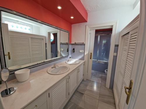 a bathroom with two sinks and a large mirror at Condesa del Mar adults only in Altea