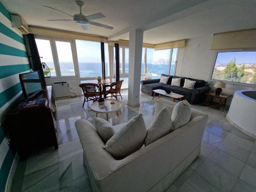 a living room with a couch and a table at Condesa del Mar adults only in Altea