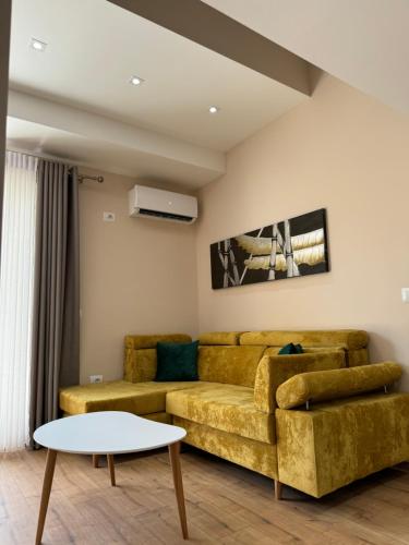 a living room with a couch and a table at Haris Apartments Tirana in Tirana