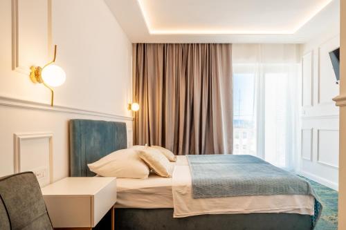 a hotel room with a bed and a window at Hotel Krilo in Podstrana