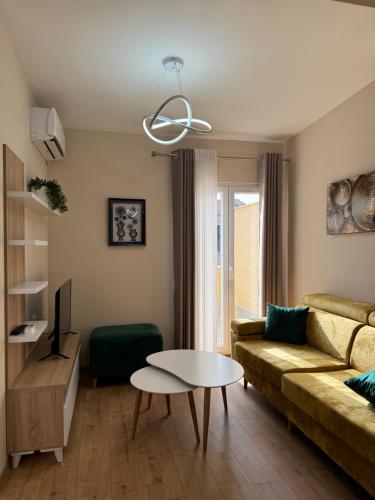 a living room with a couch and a table at Haris Apartments Tirana in Tirana