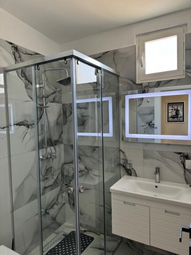 a bathroom with a shower and a sink at Haris Apartments Tirana in Tirana